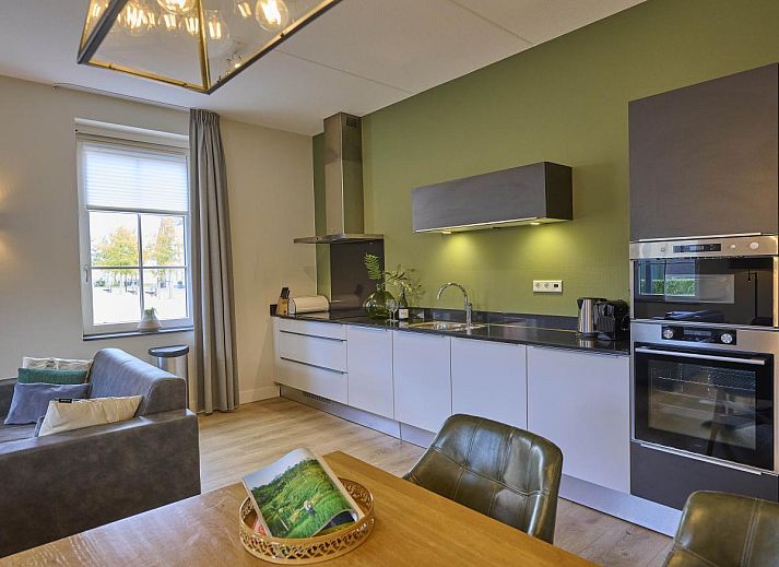 Front view of Sauna Zee accommodation in Colijnsplaat, North Beveland with colorful flowers.