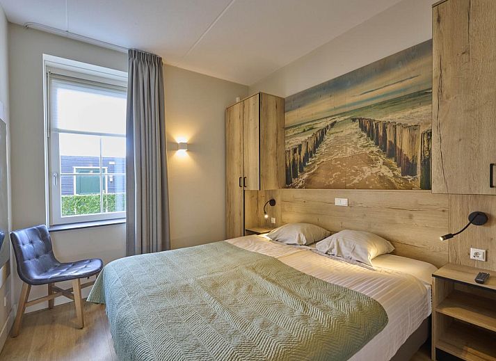 Cozy living room in Sauna Zee vacation home, Colijnsplaat, Zeeland with comfortable seating area.