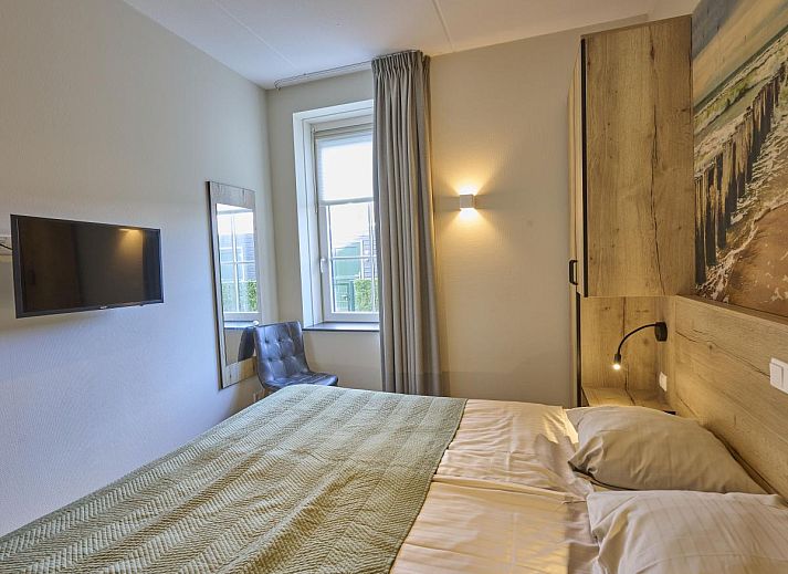 Cozy living room in Sauna Zee vacation home, Colijnsplaat, Zeeland with comfortable seating area.