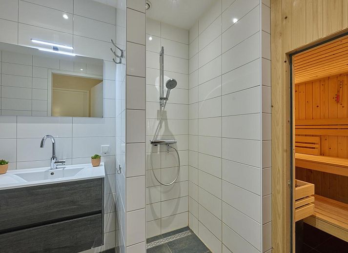 Cozy living room in Sauna Zee vacation home, Colijnsplaat, Zeeland with comfortable seating area.