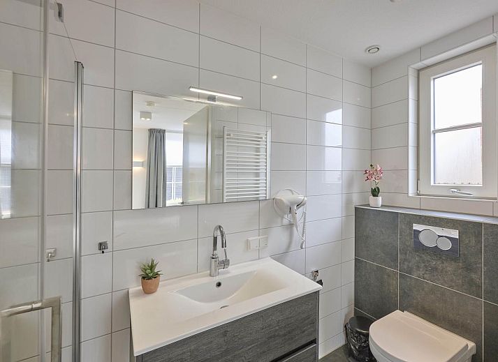 Gezellige woonkamer van Sea Deluxe vakantiehuis in Colijnsplaat, Noord-Beveland, met comfortabele banken en moderne inrichting.