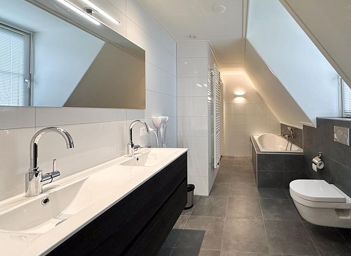 Gemuetliches Wohnzimmer im Ferienhaus Perfektion am Strand, Colijnsplaat, mit bequemer Sitzecke und Kamin.