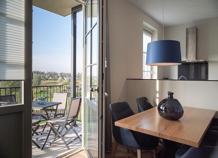 Charming entrance to SeaLuxe Residence vacation home in Colijnsplaat, North Beveland, surrounded by flowering plants.