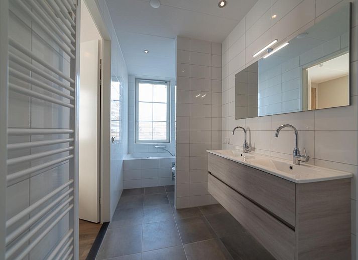 Bright interior space of SeaLuxe Residence vacation home in Colijnsplaat, with comfortable sitting area and dining area.