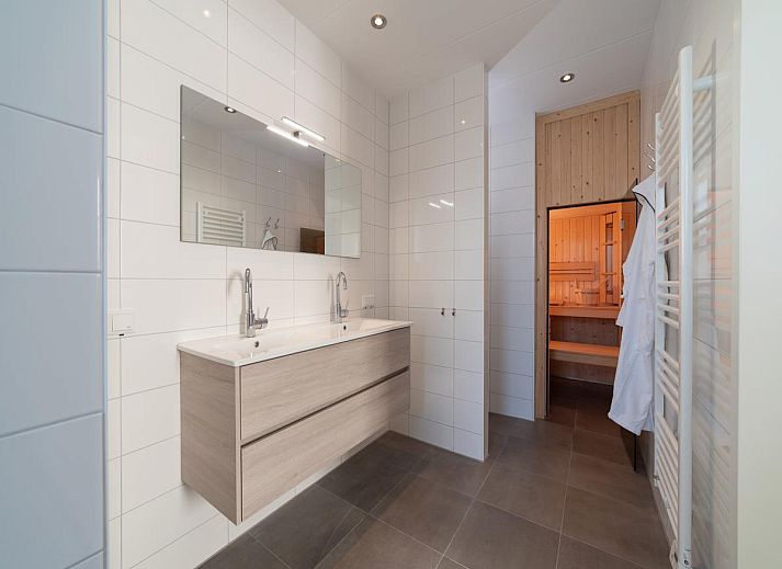 Modern living room of SeaLuxe Residence vacation home in Colijnsplaat, ideal for relaxation and coziness.