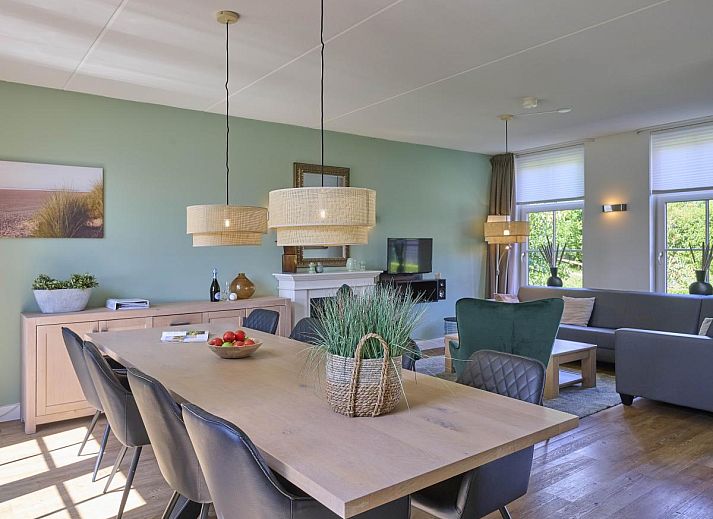 Gezellig terras bij Ocean Ease 49 in Colijnsplaat, Noord-Beveland, met ruime eettafel en parasol voor buitenmaaltijden.