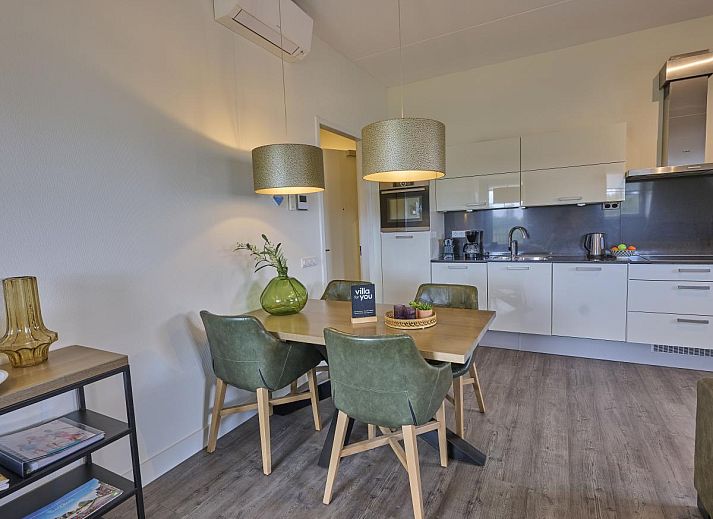 Cozy living room of Sauna Zee 27H in Colijnsplaat, North Beveland, with comfortable sofas and a modern fireplace.