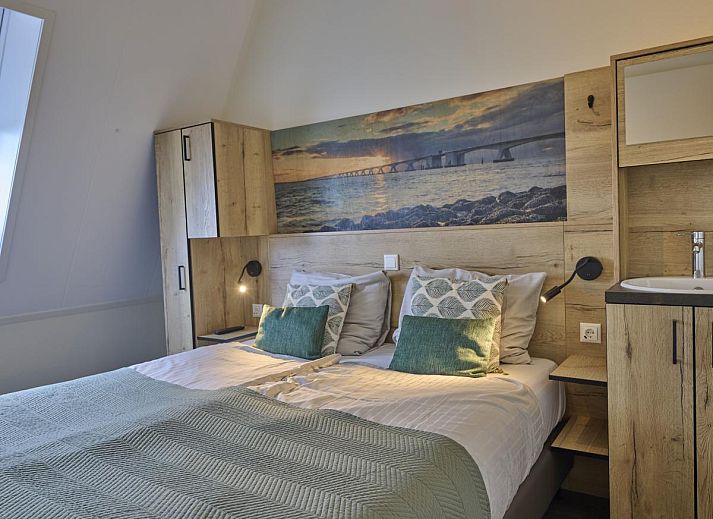 Cozy living room of Sauna Zee 27H vacation home in Colijnsplaat, North Beveland, with modern decor and lots of natural light.