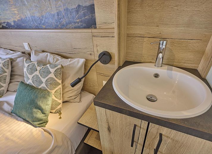 Cozy living room of Sauna Zee 27H vacation home in Colijnsplaat, North Beveland, with modern decor and lots of natural light.