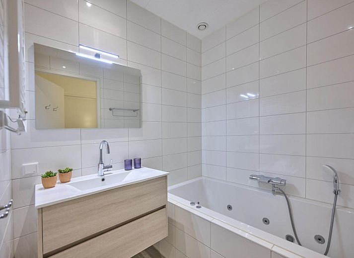 Cozy fireplace in Sauna Zee 27H, a vacation home in Colijnsplaat, North Beveland, Zeeland, offers cozy warmth and atmosphere.