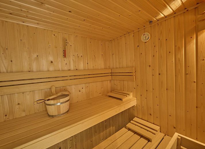 Cozy fireplace in Sauna Zee 27H, a vacation home in Colijnsplaat, North Beveland, Zeeland, offers cozy warmth and atmosphere.