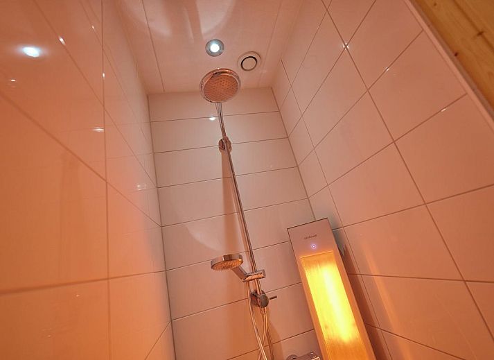 Cozy fireplace in Sauna Zee 27H, a vacation home in Colijnsplaat, North Beveland, Zeeland, offers cozy warmth and atmosphere.