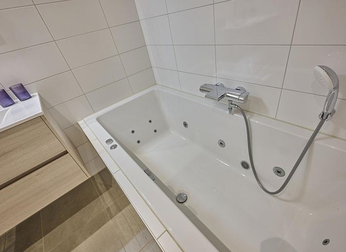 Cozy fireplace in Sauna Zee 27H, a vacation home in Colijnsplaat, North Beveland, Zeeland, offers cozy warmth and atmosphere.