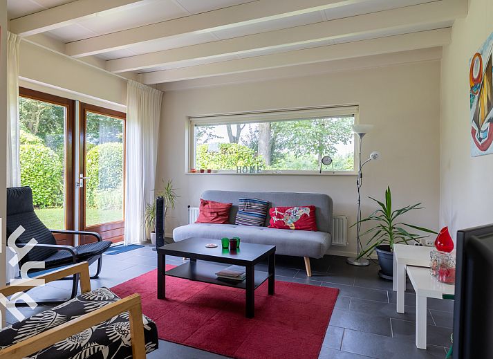 Gemuetliches Wohnzimmer des Ferienhauses ZE167 in Kamperland mit Blick in den Garten.