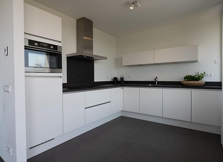 Gezellige zithoek in Duinvallei 39, De Groote Duynen, Kamperland, met comfortabele banken en een open haard.