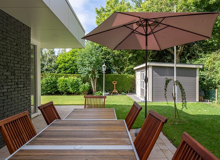 Gezellige woonkamer van Iepenlaan 3 | Ruiterplaat vakantiehuis in Kamperland met uitzicht op de tuin.