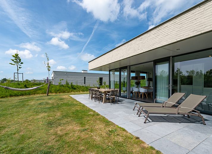 Cozy living room in Duinvallei 38 | De Groote Duynen, Kamperland, with modern fireplace and spacious seating area.