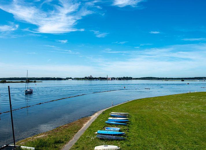 Spacious terrace with comfortable seating at Veerse Muze 7th cottage, Kamperland, overlooking the waters of North Beveland.