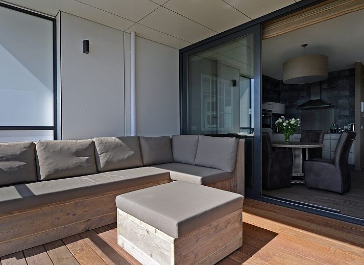 Spacious terrace with comfortable seating at Veerse Muze 7th cottage, Kamperland, overlooking the waters of North Beveland.