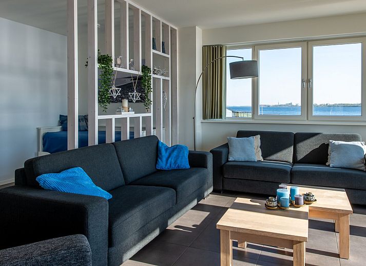 Lichte woonkamer in Penthouse 4a Schotsman Watersport, Kamperland, met panoramisch uitzicht op het water.