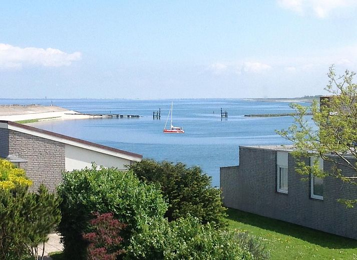 Meerblick in VZ1178 Ferienhaus in Kamperland, Noord-Beveland, mit einem Segelboot auf dem Wasser.