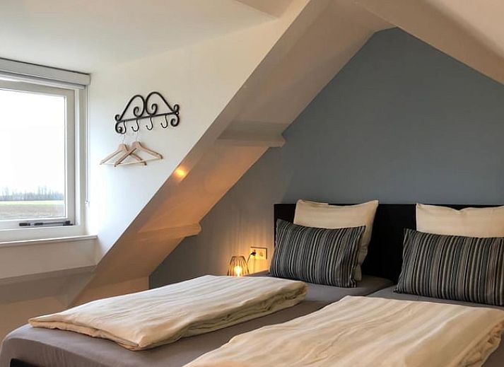 Geniet van het uitzicht op het platteland vanaf het terras van Vakantiehuis in Kamperland, Noord-Beveland, Zeeland.