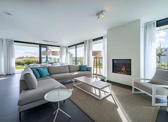 Sunny terrace with deck chairs at Duinvallei 06, vacation home in Kamperland, Noord-Beveland, Zeeland.