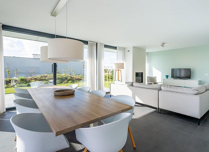 Sunny terrace with deck chairs at Duinvallei 06, vacation home in Kamperland, Noord-Beveland, Zeeland.