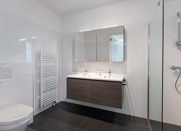 Stijlvolle zithoek met uitzicht op tuin in Waterlijn 05 bungalow, Kamperland, Zeeland.