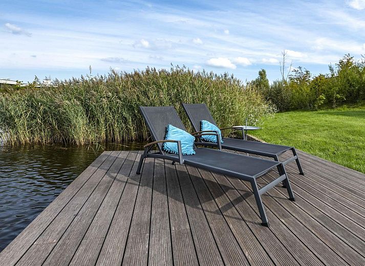 Lichte woonkamer met comfortabele bank in Waterlijn 05 bungalow, Zeeland.