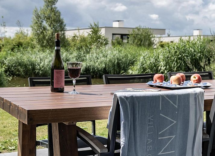 Relax on the veranda of Duinvallei 10 | De Groote Duynen in Kamperland, a luxury vacation home surrounded by the tranquility of Zeeland.