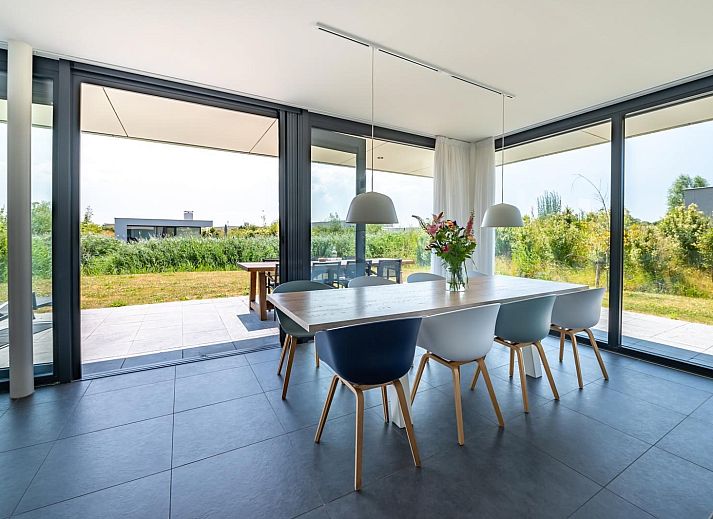 Relax on the veranda of Duinvallei 10 | De Groote Duynen in Kamperland, a luxury vacation home surrounded by the tranquility of Zeeland.