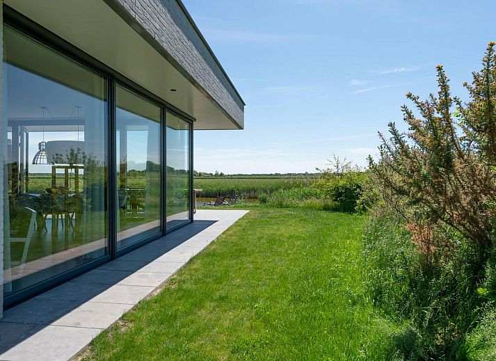 Stijlvolle woonkamer met open haard in Waterlijn 06 bungalow, Kamperland, Zeeland.