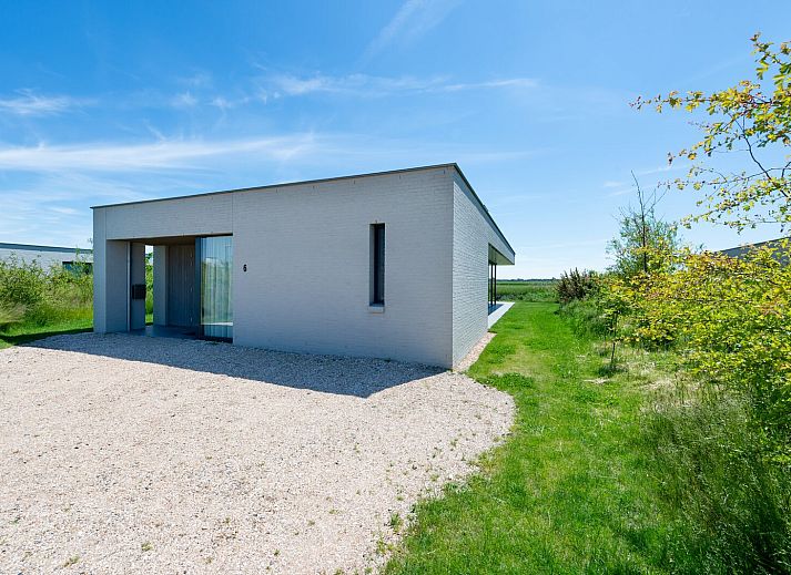 Stijlvolle woonkamer met open haard in Waterlijn 06 bungalow, Kamperland, Zeeland.