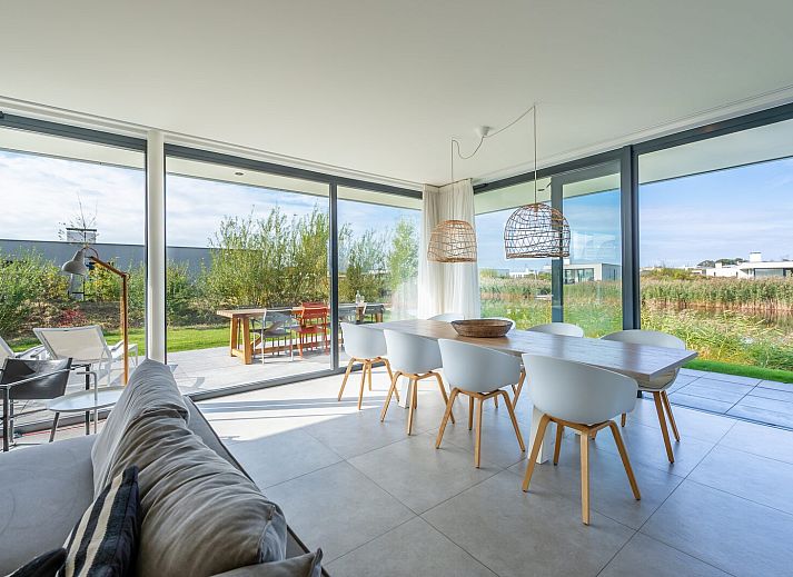 Dining room overlooking nature at Waterline 09, vacation home in Kamperland, Zeeland.