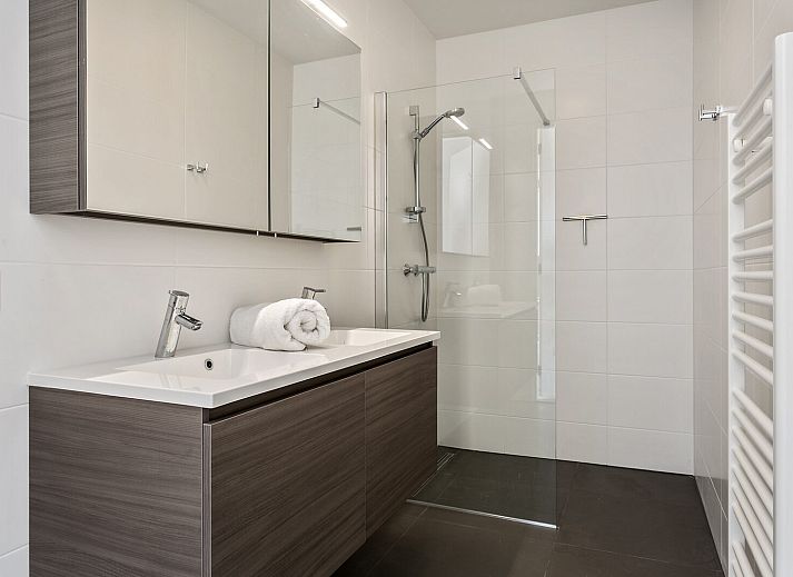 Moderne woonkamer met uitzicht op de tuin in Waterlijn 13, De Groote Duynen, vakantiehuis in Kamperland.