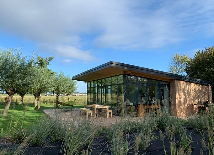 Modern vacation home in Kamperland with spacious veranda surrounded by nature, perfect for relaxation in North Beveland, Zeeland.