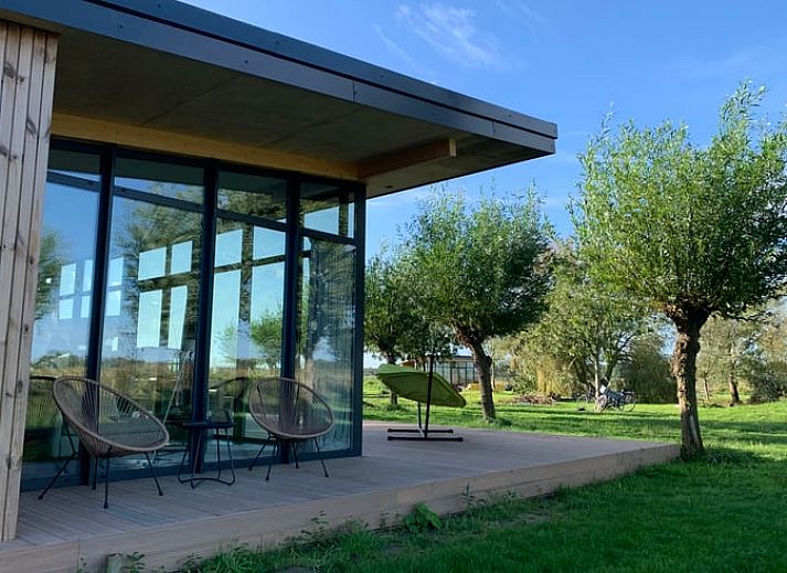 Modern vacation home in Kamperland with spacious veranda surrounded by nature, perfect for relaxation in North Beveland, Zeeland.
