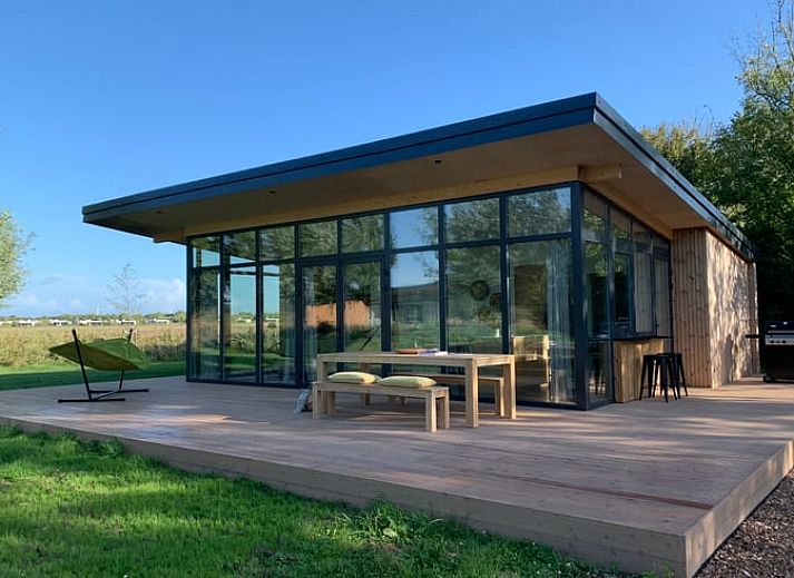 Modern vacation home in Kamperland with spacious veranda surrounded by nature, perfect for relaxation in North Beveland, Zeeland.