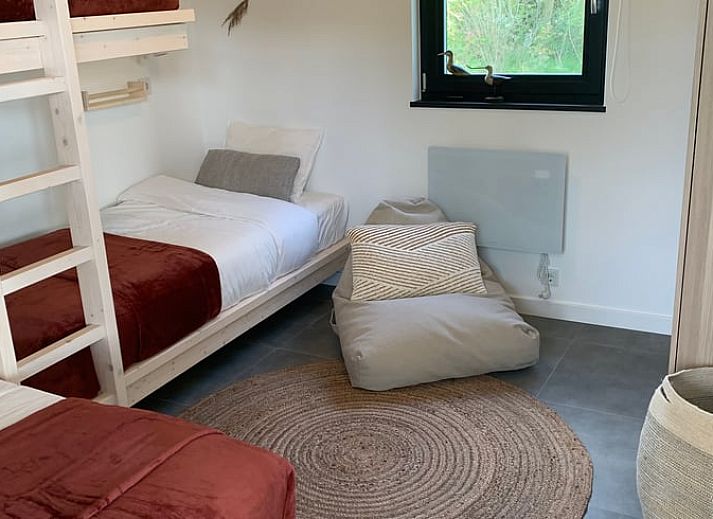 Terrace of vacation home in Kamperland with comfortable chairs and views of green surroundings in North Beveland, Zeeland.