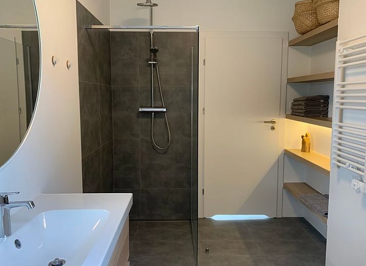 Terrace of vacation home in Kamperland with comfortable chairs and views of green surroundings in North Beveland, Zeeland.