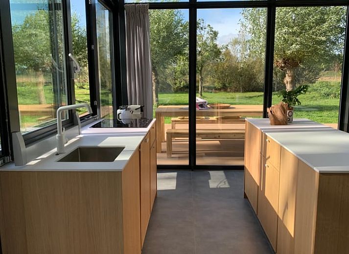 Modern kitchen of vacation home in Kamperland with wooden finish and stylish decoration in North Beveland, Zeeland.