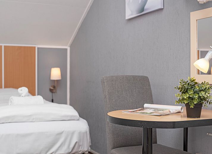 Cozy living room in Villapark Livingstone 4-person villa 4BE, Burgh-Haamstede, with dining area and large windows.