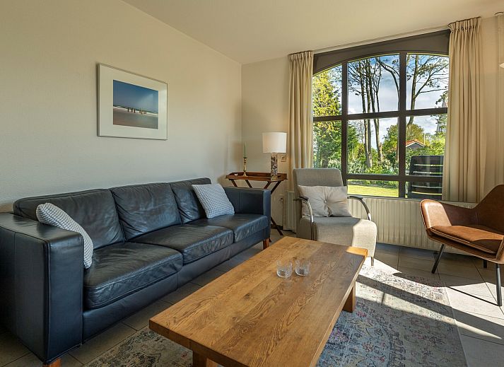 Terrace of Holiday home Schouwse Duin 35 in Burgh-Haamstede with garden table and parasol for summer days in Zeeland.