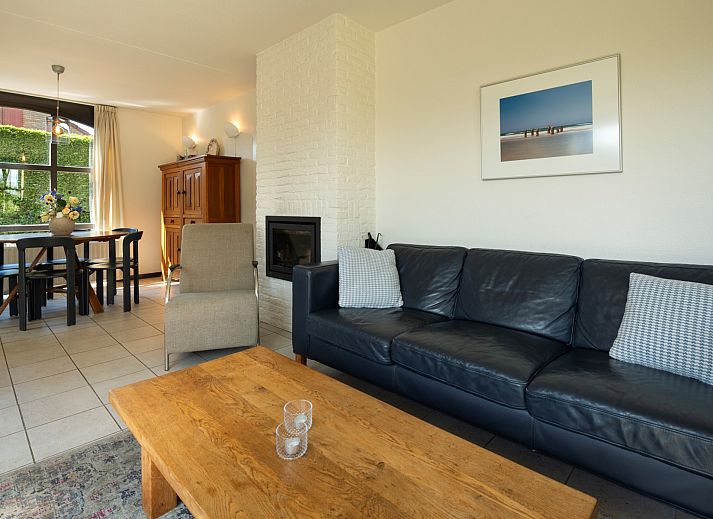 Terrace of Holiday home Schouwse Duin 35 in Burgh-Haamstede with garden table and parasol for summer days in Zeeland.