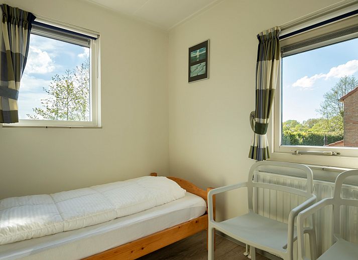 Cozy sitting area in Holiday home Schouwse Duin 35, Burgh-Haamstede, overlooking the garden in Zeeland.