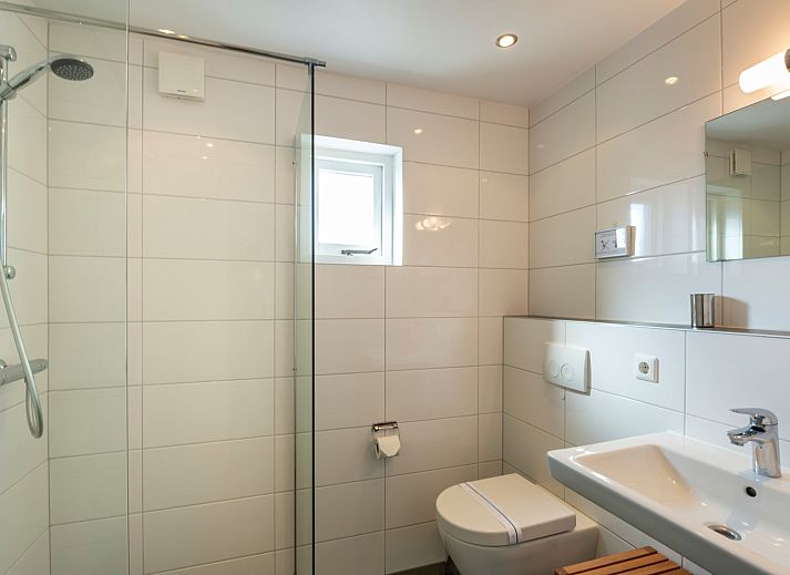 Cozy sitting area in Holiday home Schouwse Duin 35, Burgh-Haamstede, overlooking the garden in Zeeland.