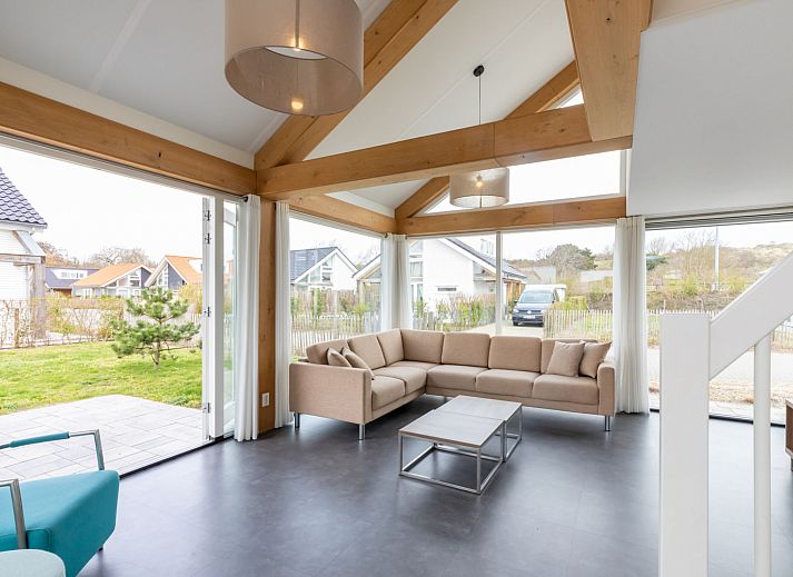 Spacious living room in Holiday home Duinzicht Renesse with modern furnishings and lots of natural light.
