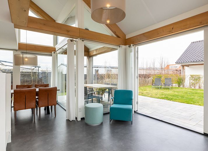 Spacious living room in Holiday home Duinzicht Renesse with modern furnishings and lots of natural light.