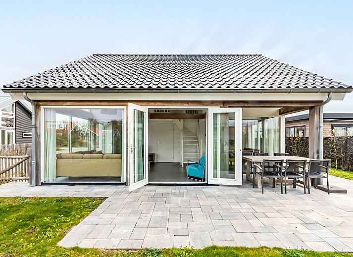 Spacious living room in Holiday home Duinzicht Renesse with modern furnishings and lots of natural light.